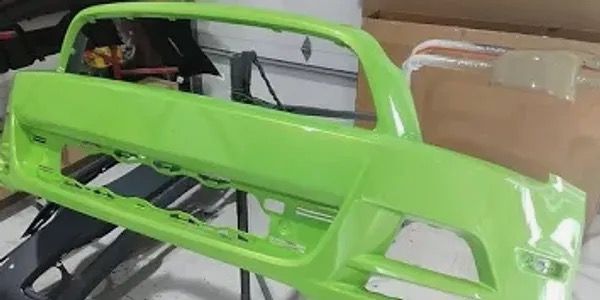 Freshly painted bright green front bumper — car parts painting at Astro Collision